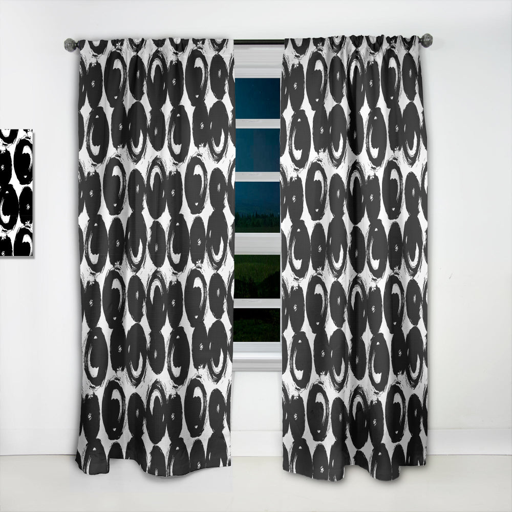Black and white patterned curtains with a window in between
