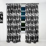 Black and white patterned curtains with a window in between