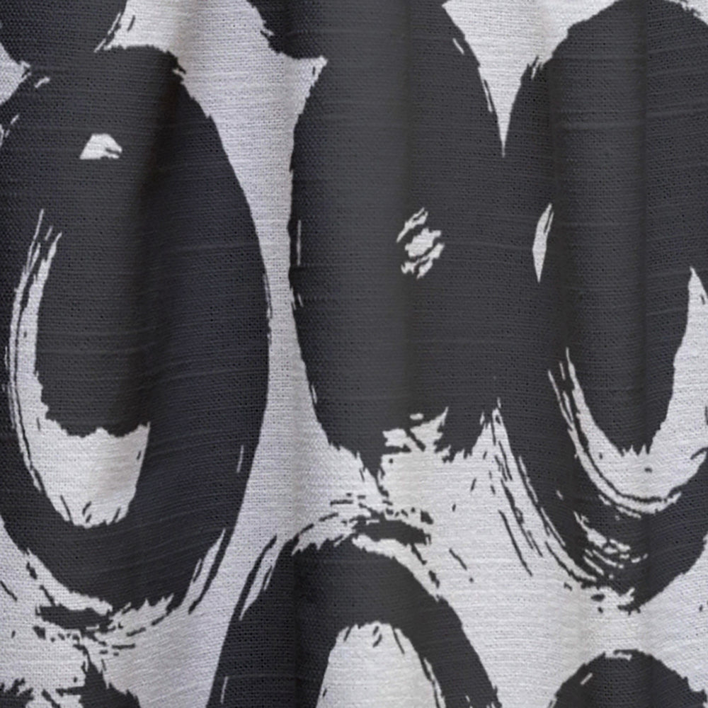 Close-up of a black and white patterned fabric with abstract shapes.