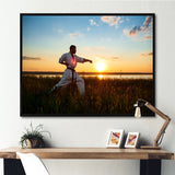 Man Training Karate In Field At Sunrise - Aerobic & Bodybuilding Canvas Wall Art