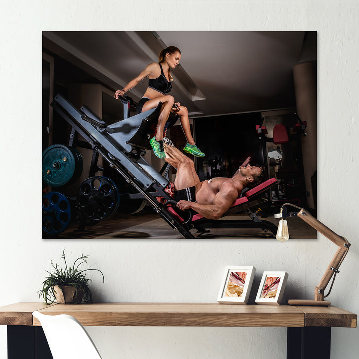 Man Doing Leg Presses With His Trainer - Aerobic &amp; Bodybuilding Canvas Wall Art