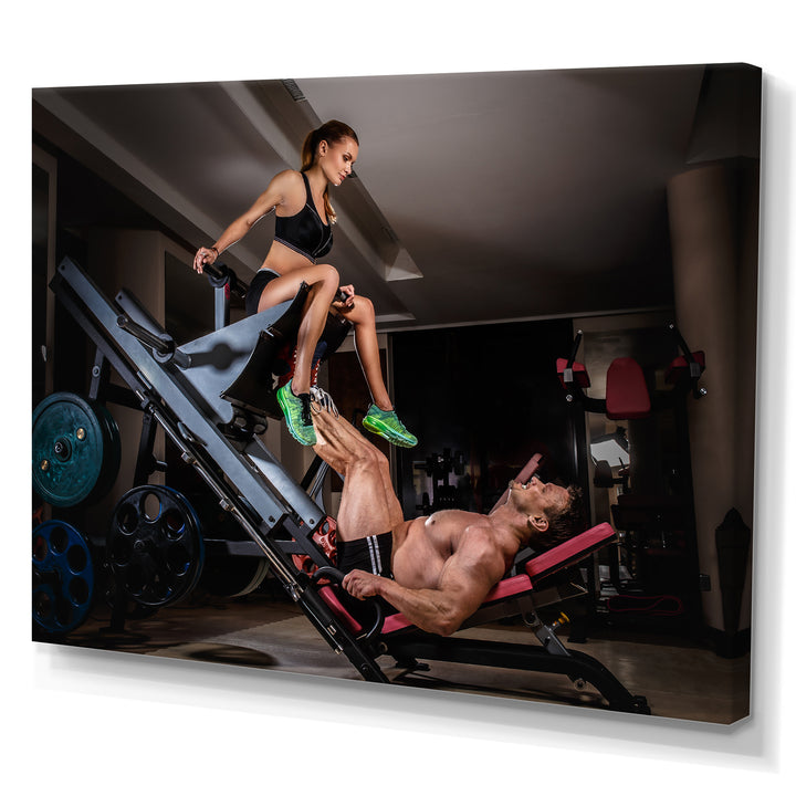 Man Doing Leg Presses With His Trainer - Aerobic &amp; Bodybuilding Canvas Wall Art