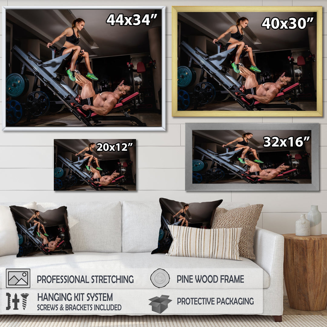 Man Doing Leg Presses With His Trainer - Aerobic &amp; Bodybuilding Canvas Wall Art