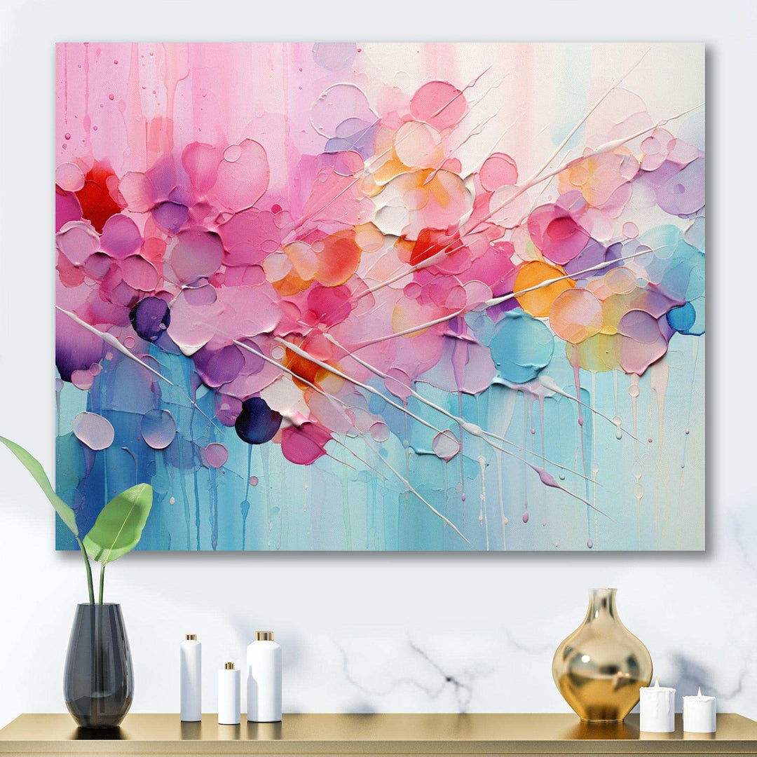 Abstract art piece with colorful circles on a wall above a table with decorative items.