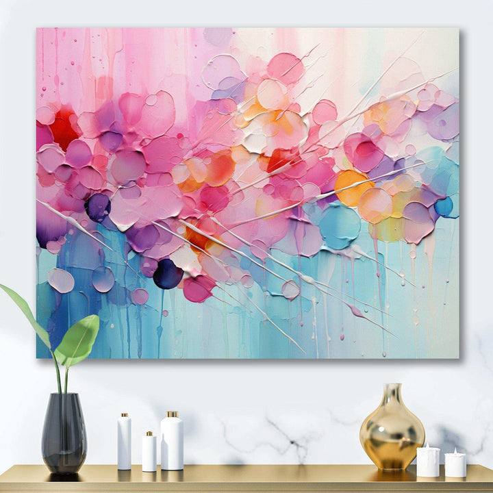 Abstract art piece with colorful circles on a wall above a table with decorative items.