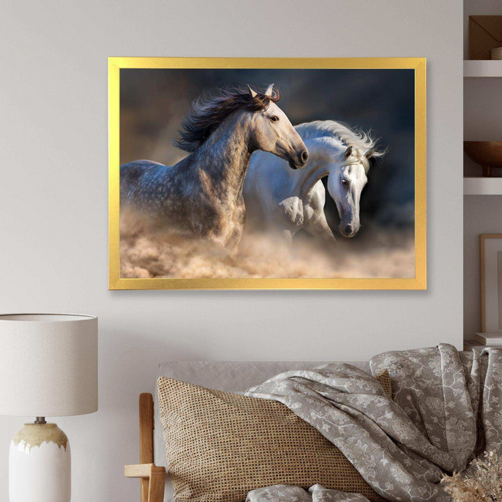 Horses run in dust