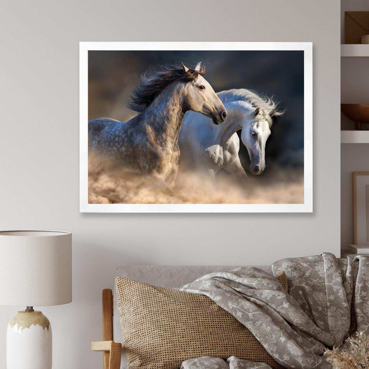 Horses run in dust